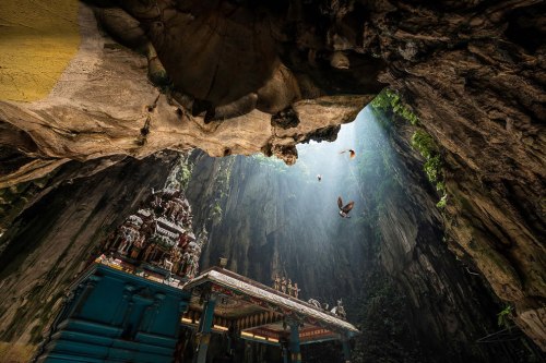 Birds-sunlight-and-a-temple-inside-Batu-Caves-in-Malaysia